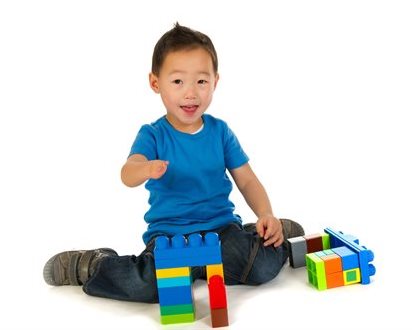 Little-boy-with-building-blocks-on-white-background