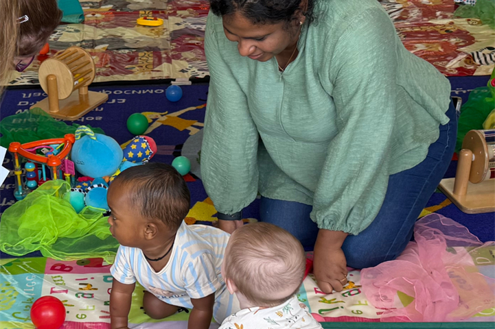 Mum and babies on a playmat